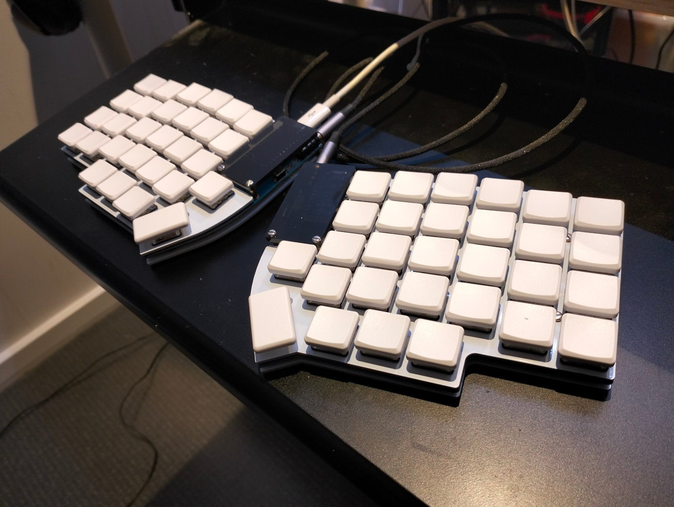 Lily58 split keyboard with low profile keys and white keycaps.